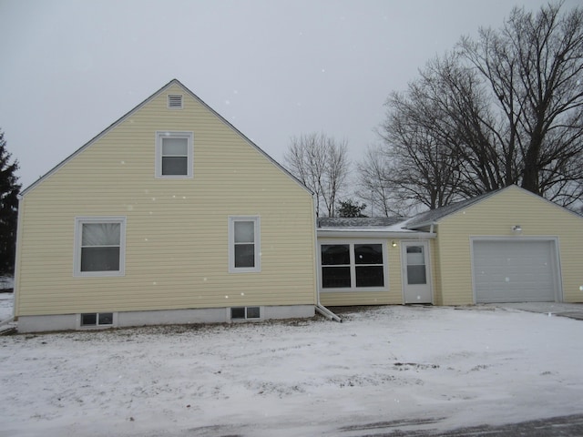 view of snowy exterior with a garage