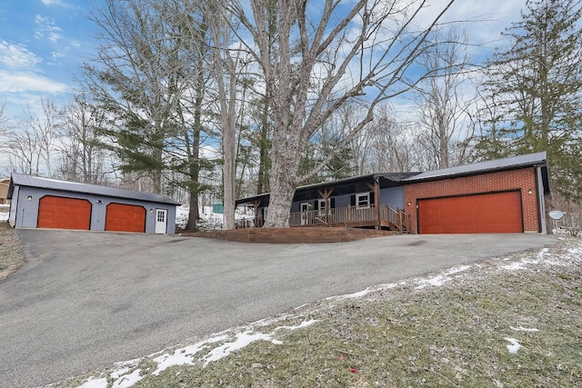 ranch-style house with a porch and a garage