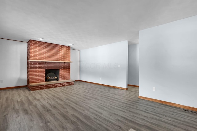 unfurnished living room featuring hardwood / wood-style floors and a fireplace