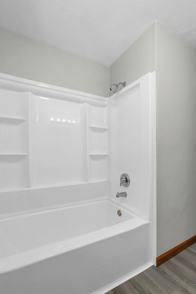 bathroom with  shower combination and hardwood / wood-style floors