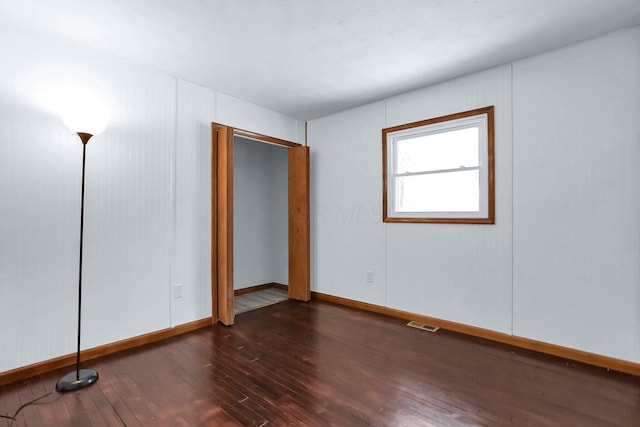 unfurnished room with dark hardwood / wood-style floors