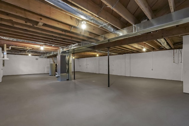 basement featuring heating unit and gas water heater