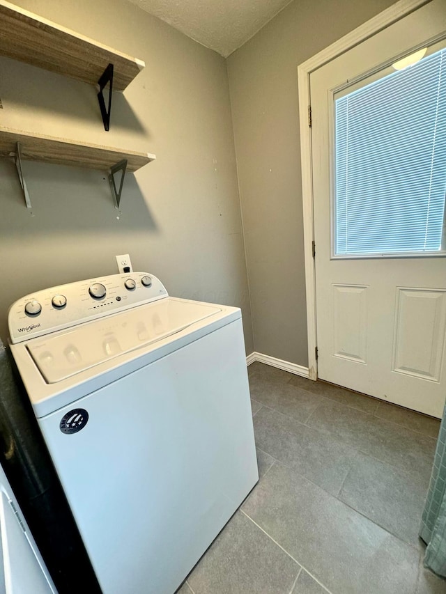 washroom featuring tile patterned flooring, washer / clothes dryer, baseboards, and laundry area