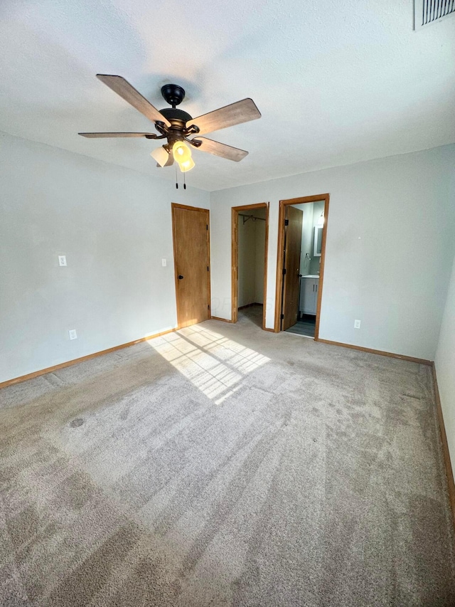 interior space with ceiling fan and light colored carpet