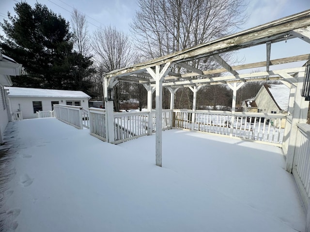 snow covered patio featuring a wooden deck