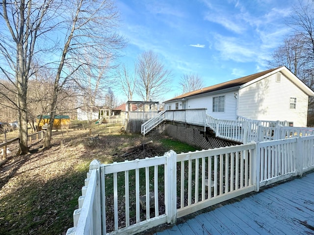 view of side of home with stairs and a wooden deck