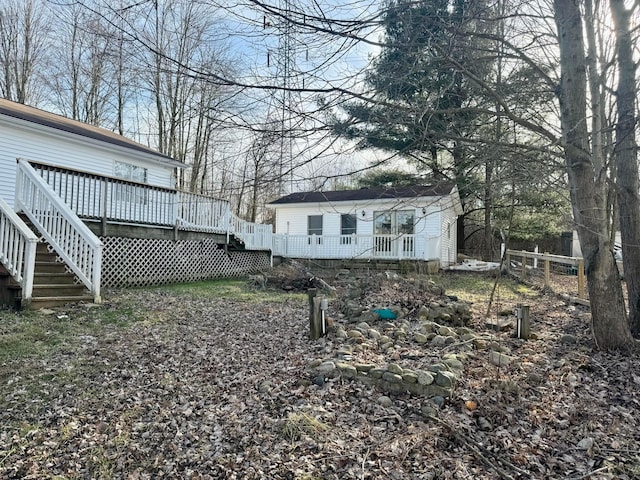 view of yard with fence, stairway, and a wooden deck