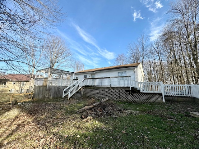 rear view of property featuring a wooden deck