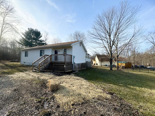 view of front facade featuring crawl space, fence, a deck, and a front lawn