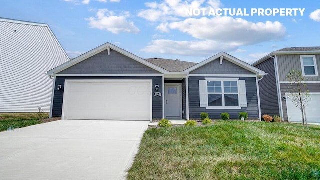 view of front of home with a front yard and a garage