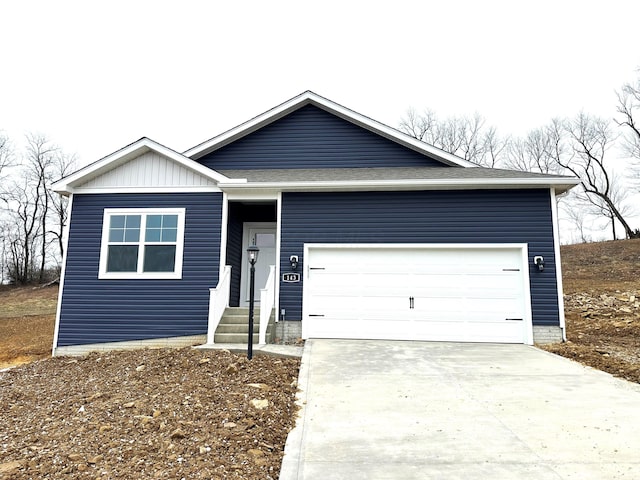 single story home featuring an attached garage, driveway, and roof with shingles