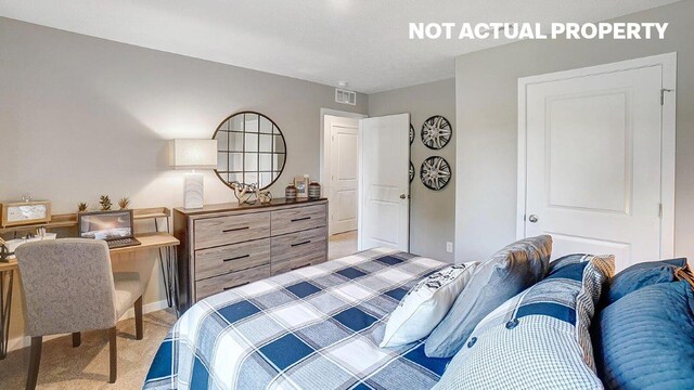 bedroom with light colored carpet