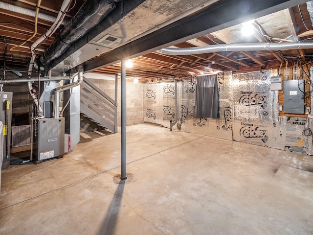 basement with electric panel and heating unit