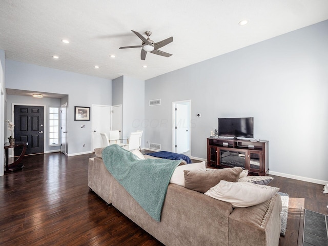 living room with ceiling fan and dark hardwood / wood-style floors