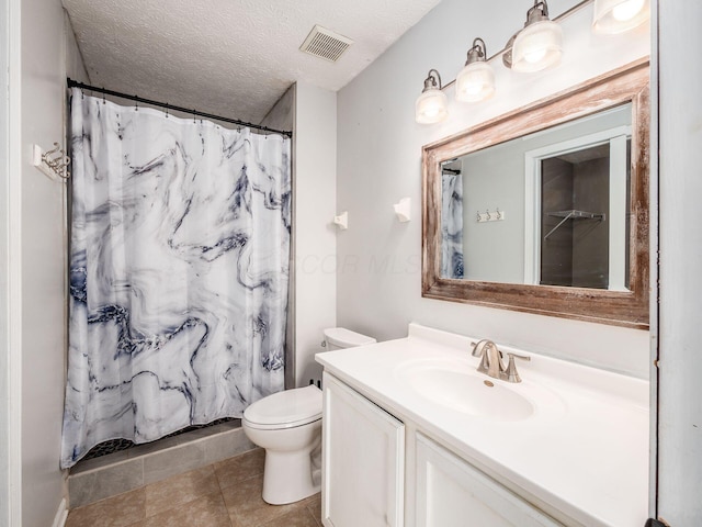 bathroom with toilet, a shower with shower curtain, tile patterned floors, a textured ceiling, and vanity