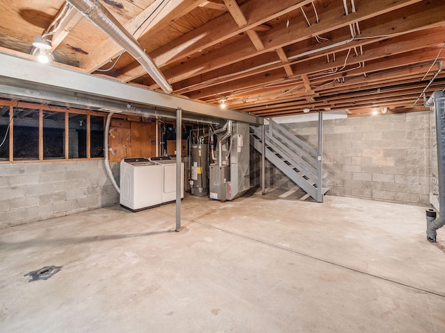 basement with separate washer and dryer, heating unit, and gas water heater