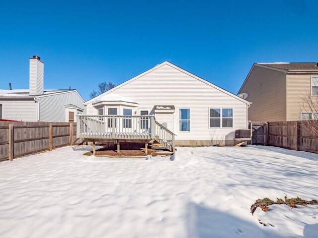 snow covered rear of property with a deck and central air condition unit