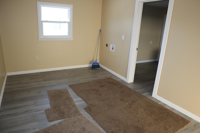 clothes washing area with hardwood / wood-style flooring and washer hookup