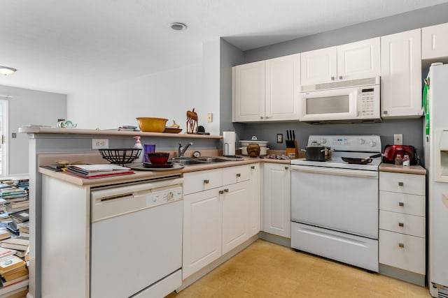 kitchen featuring sink, white appliances, and white cabinets