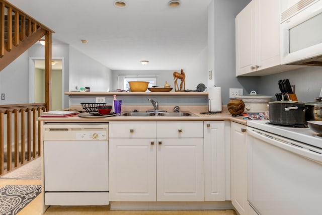 kitchen featuring white appliances, sink, and white cabinets