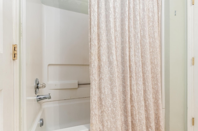 bathroom with shower / tub combo with curtain