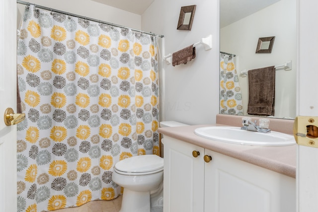 bathroom featuring vanity, toilet, and tile patterned flooring