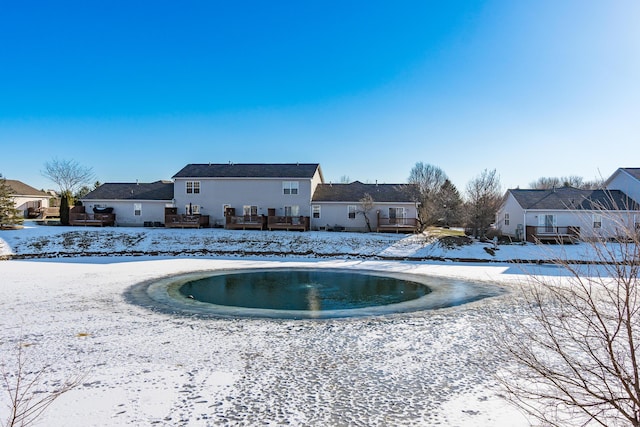 snow covered property with a wooden deck