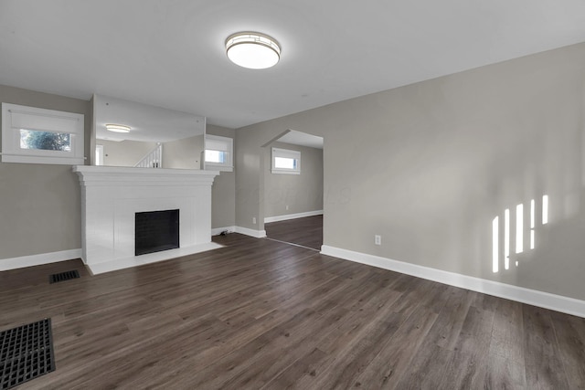 unfurnished living room with dark hardwood / wood-style flooring