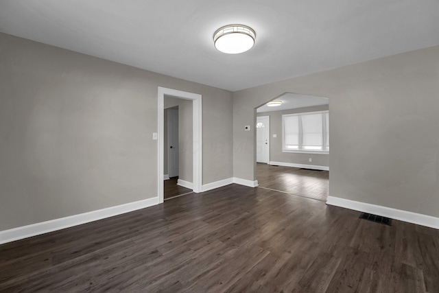 empty room with dark wood-type flooring