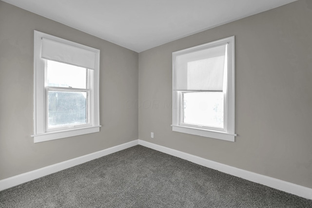 empty room with dark colored carpet