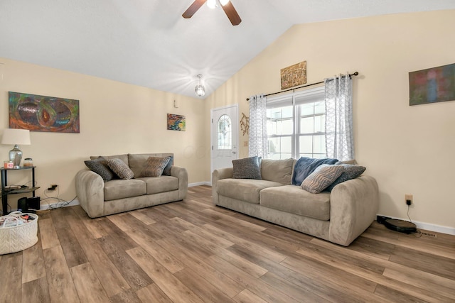 living room with hardwood / wood-style floors, vaulted ceiling, and ceiling fan