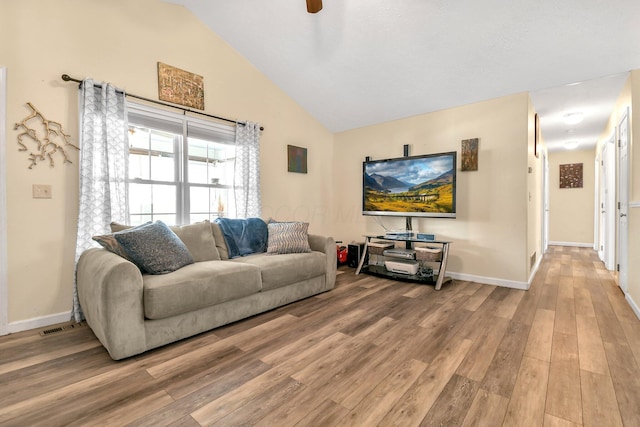 living room with wood-type flooring and high vaulted ceiling