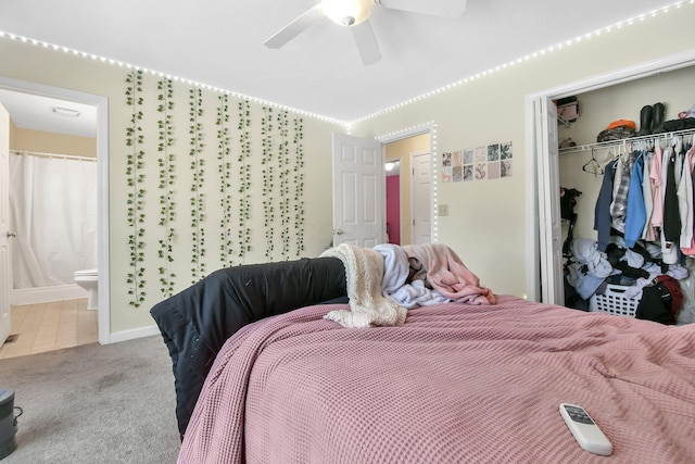 carpeted bedroom with connected bathroom, ceiling fan, and a closet