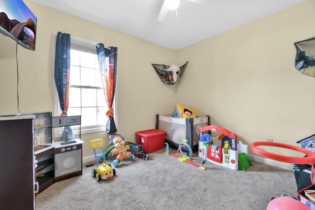 recreation room with light carpet, ceiling fan, and a healthy amount of sunlight