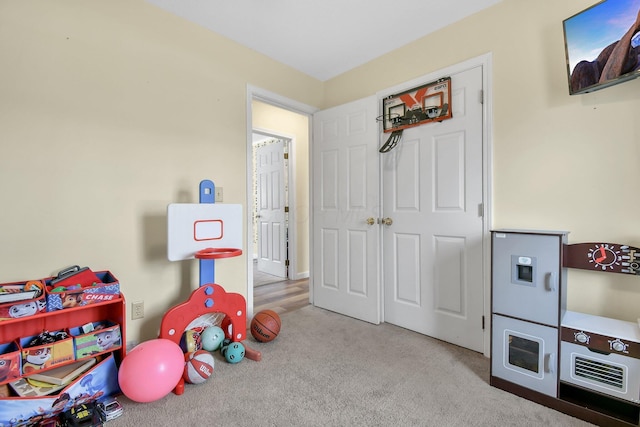 game room featuring light carpet