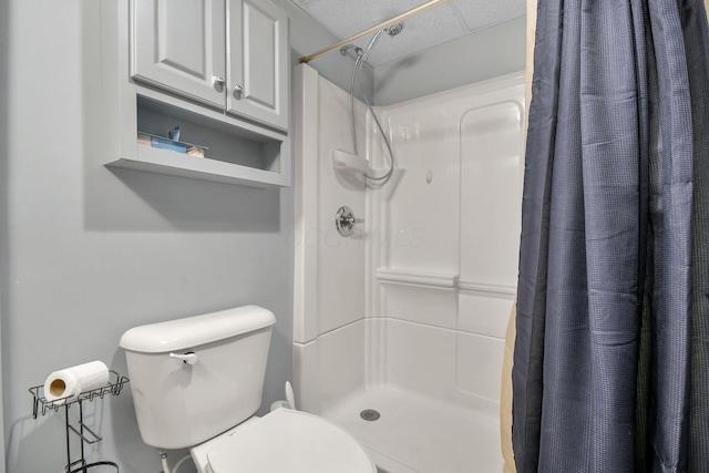 bathroom with a shower with curtain and toilet