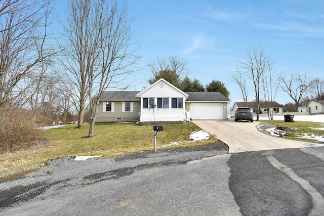 single story home featuring a garage and a front yard