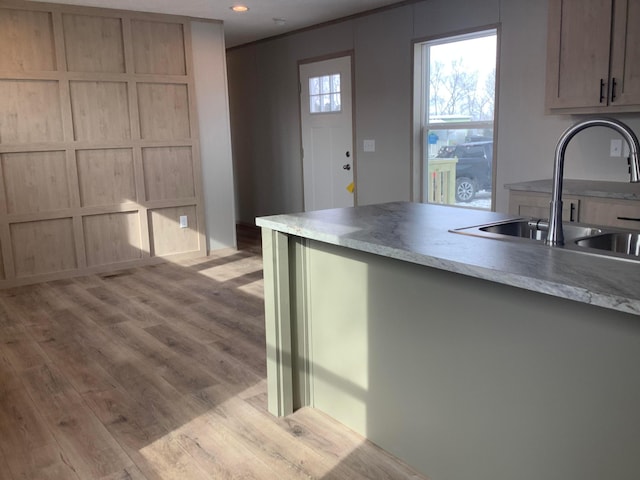 kitchen with light hardwood / wood-style floors, sink, and light brown cabinets