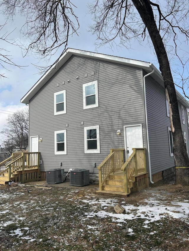 snow covered property with cooling unit