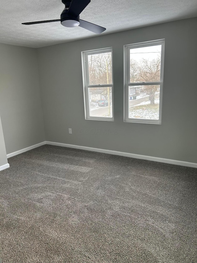 unfurnished room with ceiling fan, carpet, and a textured ceiling