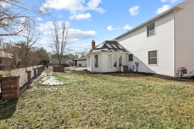 exterior space with cooling unit and a lawn