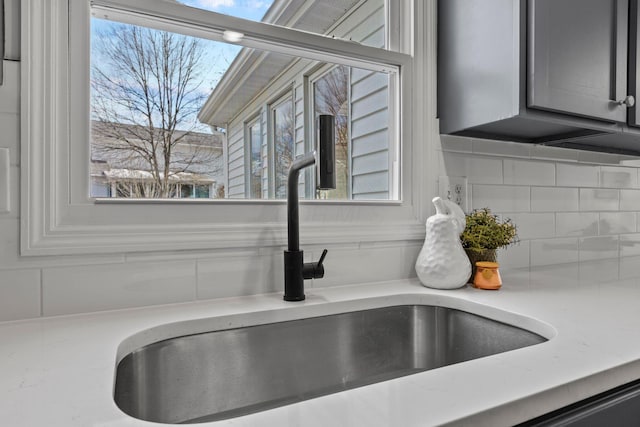 details featuring sink and decorative backsplash