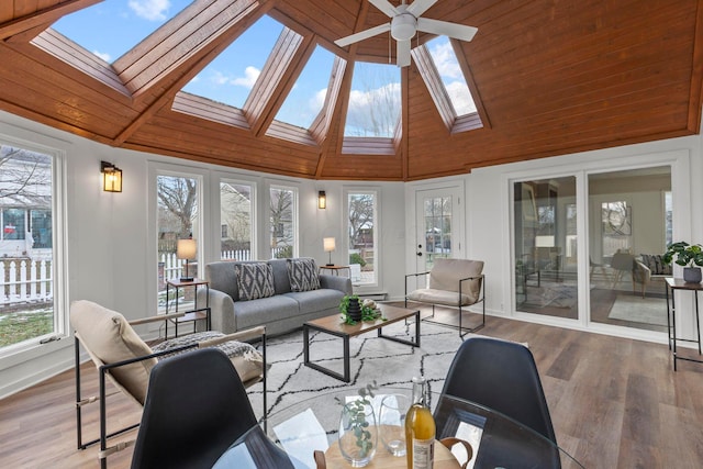 sunroom / solarium with ceiling fan and lofted ceiling with skylight