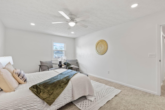 bedroom featuring ceiling fan, carpet flooring, and a textured ceiling