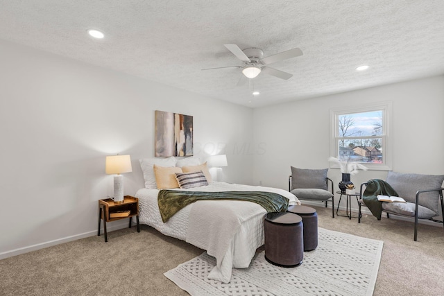 carpeted bedroom featuring ceiling fan and a textured ceiling