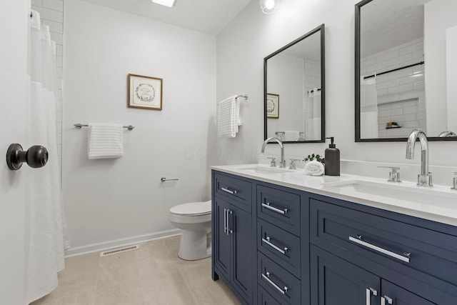 bathroom featuring vanity, tile patterned flooring, a shower with curtain, and toilet