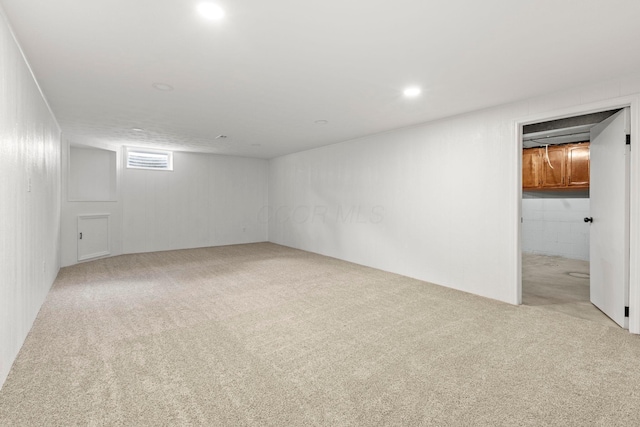 basement featuring light colored carpet