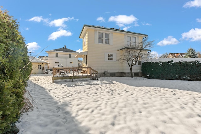 rear view of property featuring a deck