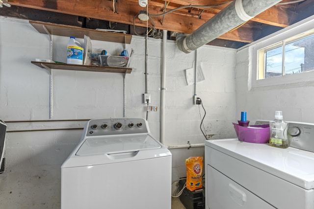 clothes washing area with separate washer and dryer