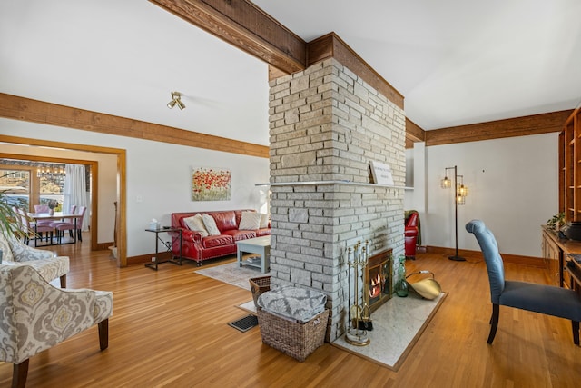 living room featuring wood-type flooring and a fireplace